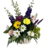 Fresh assortment of blooms arranged in a basket, using larkspur, gerbera daisies
