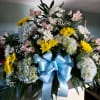 Blue hydrangea, white and yellow mums, light pink alstroemeria lilies accented with