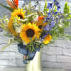 An assortment of fresh flowers in a large vase.