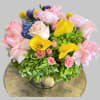 Pink roses and yellow color lilies come together with green hydrangea for
