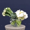 This modern arrangement is artfully designed with tulips and luxurious phalaenopsis orchids
