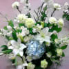 Lilies, hydrangea, and other flowers, in white and blue.