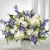 Designed with a fresh mix of blue and white flowers, this tribute
