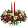 The holiday table shines with this festive centerpiece of roses and winter