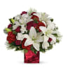 This festive holiday bouquet includes red roses and white asiatic lilies presented