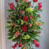 Deep red blooms with the enduring vitality of lush green foliage is