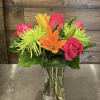 A bright and colorful mix of orange asiatic lilies, green spider mums