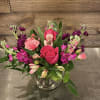 A Mix of pink and purple flowers, including roses, stock, and alstromeria