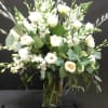 This beautiful arrangement make with all white flowers , roses , lilies.