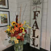 A beautiful Fall inspired arrangement with seasonal flowers such as asiatic lilies