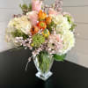 A lush collection of garden florals artfully arranged in an attractive clear