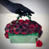 Evening Clutch is a unique floral arrangement of red and black roses