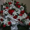 Red and white daisies, white lilies, and red and white carnations with