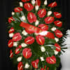 Red and Green Tropical Sympathy Piece with red peace lilies and tropical