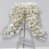 A beautiful funeral arrangement filled with hydrangea, roses and orchids. The arrangement
