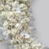 A beautiful funeral arrangement filled with hydrangea, roses and orchids. The arrangement