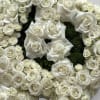 A custom music note funeral arrangement filled with fresh florals; hydrangea, roses