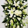 Beautiful primary white color with green accents, an elegant standing spray to