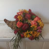 Beautiful rich fall colors roses, daisies, carnations, apples and greens cornucopia centerpiece