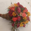 Beautiful rich fall colors roses, daisies, carnations, apples and greens cornucopia centerpiece