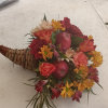 Beautiful rich fall colors roses, daisies, carnations, apples and greens cornucopia centerpiece