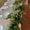 Lush greenery, baby&#039;s breath and roses table garland