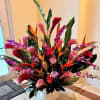 Selective Tropical Flowers arranged in a ceramic container. Approx. 30 inches tall
