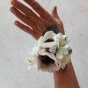 Beautiful white anemones, spray carnations and alstroemeria in a white corsage (prom/homecoming/wedding)