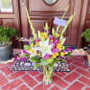 A beautiful bouquet of lavender roses, purple orchids, yellow spray roses, green