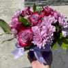 A splendid arrangement of lavender roses and daisies, accented with greenery.
Presented in
