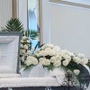 An all white tribute, this half casket spray is pure in color