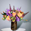 A beautiful Fall arrangement featuring roses, stock, berries, and other seasonal accents