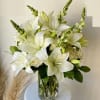 A clean bouquet of white lilies, roses, and snapdragons.

Our florists hand-design each