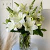 A clean bouquet of white lilies, roses, and snapdragons.

Our florists hand-design each