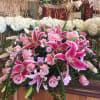 The Tranquility Casket Spray is a classic design that features stargazer lilies