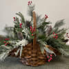 Oversized Fireside Basket, filled with artificial winter greens, berries, and pinecones.
39x22