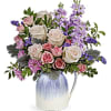 A bouquet of stock, statice, roses and chrysanthemums arranged in a pretty