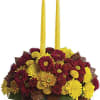 Happy yellow mums and a golden taper candle bring sunshine to your