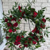 wreath filled with beautiful greens and pops of reds and white. 

All