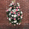 A STANDING SPRAY OF WHITE AND PINK FLOWERS.