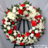 Beautiful Tribute Wreath on easel in blooms of Red and White. A