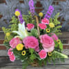 Mixed seasonal flowers I a basket shown as medium