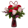 A romantic mixture of pink roses, red carnations and heather in a