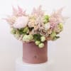 Bring beauty to the table with elegant arrangement, presented in a hat