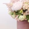 Bring beauty to the table with elegant arrangement, presented in a hat