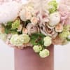 Bring beauty to the table with elegant arrangement, presented in a hat