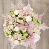 Bring beauty to the table with elegant arrangement, presented in a hat