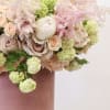 Bring beauty to the table with elegant arrangement, presented in a hat