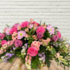 Pastel Beauty with a focus of roses, larkspur, spray roses, alstroemeria, and