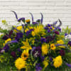 A mix of purple &amp; yellow flowers arranged in a wildflower scheme.